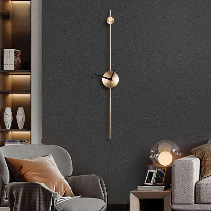 Modern wall clock on a dark gray wall with a living room setting.