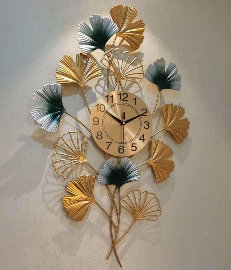 Decorative wall clock with leaf designs on a plain background