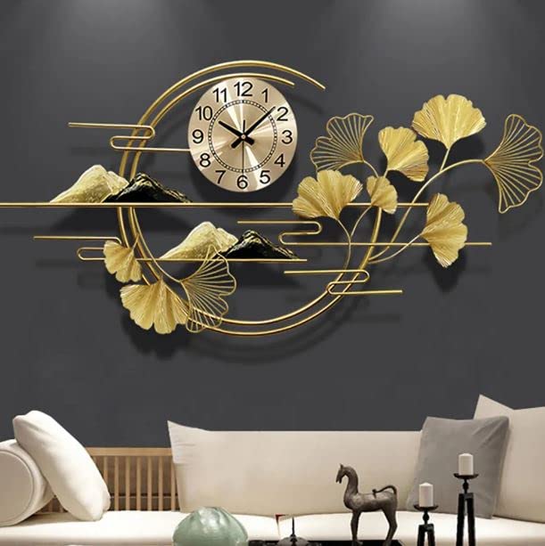 Decorative wall clock with gold leaves and mountains on a dark wall above a sofa.