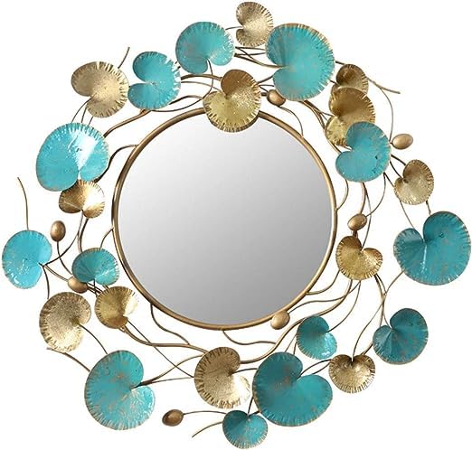 Decorative round mirror with turquoise and gold leaf designs on a white background