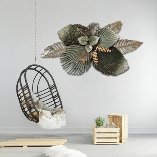 Decorative metal wall art of a flower with leaves in a room setting.