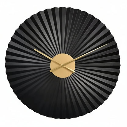 Black wall clock with gold accents on a white background