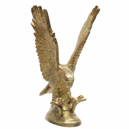 Gold eagle statue with outstretched wings on a white background
