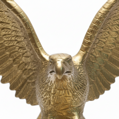 Gold eagle statue with open wings on a white background
