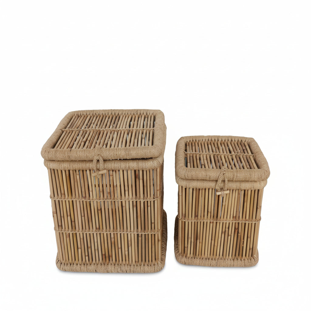 Two wicker laundry baskets on a marble floor with a white wall background.