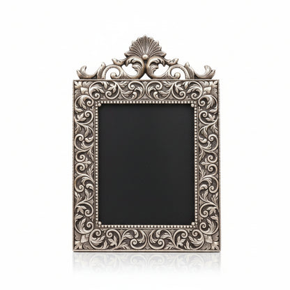 Decorative mirror with intricate silver frame on a clear background