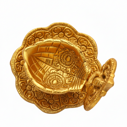 Gold decorative item with intricate patterns on a white background