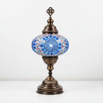 Decorative table lamp with mosaic design and bronze base on a white background