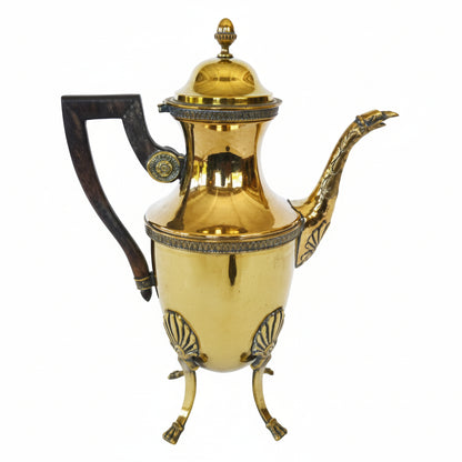 Gold teapot with wooden handle on a white background