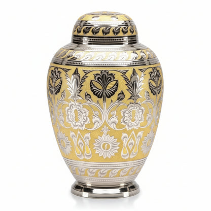Decorative urn with intricate silver patterns on a yellow background