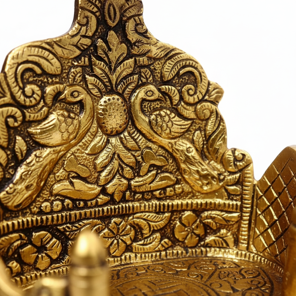 Close-up of a gold decorative item with intricate patterns and birds.