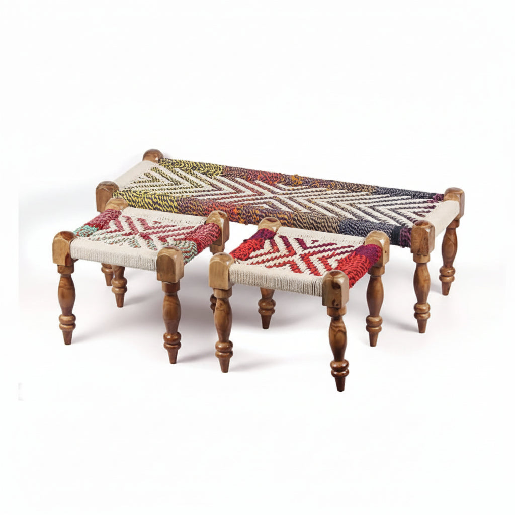 Three woven stools with colorful patterns on a white background