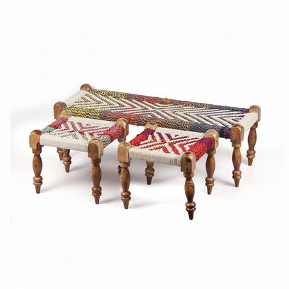 Three woven stools with colorful patterns on a white background
