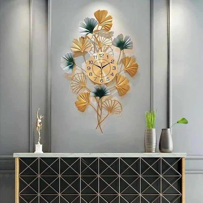 Decorative wall clock with leaf design on a gray wall
