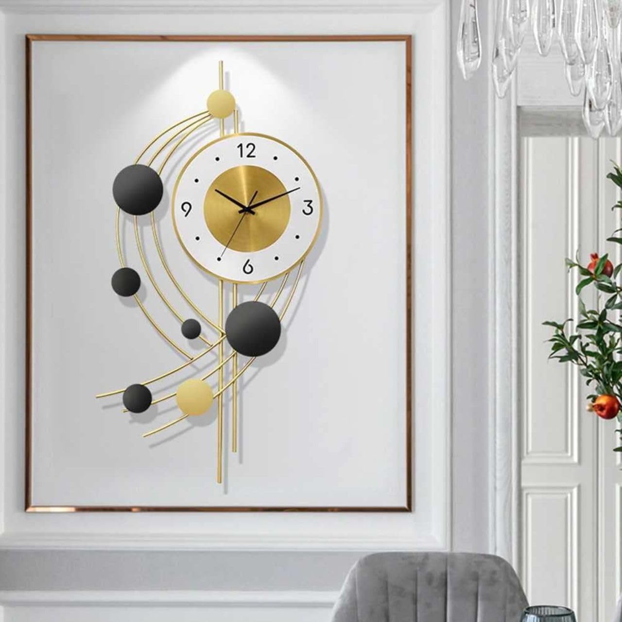 Decorative wall clock with gold and black design on a white wall.
