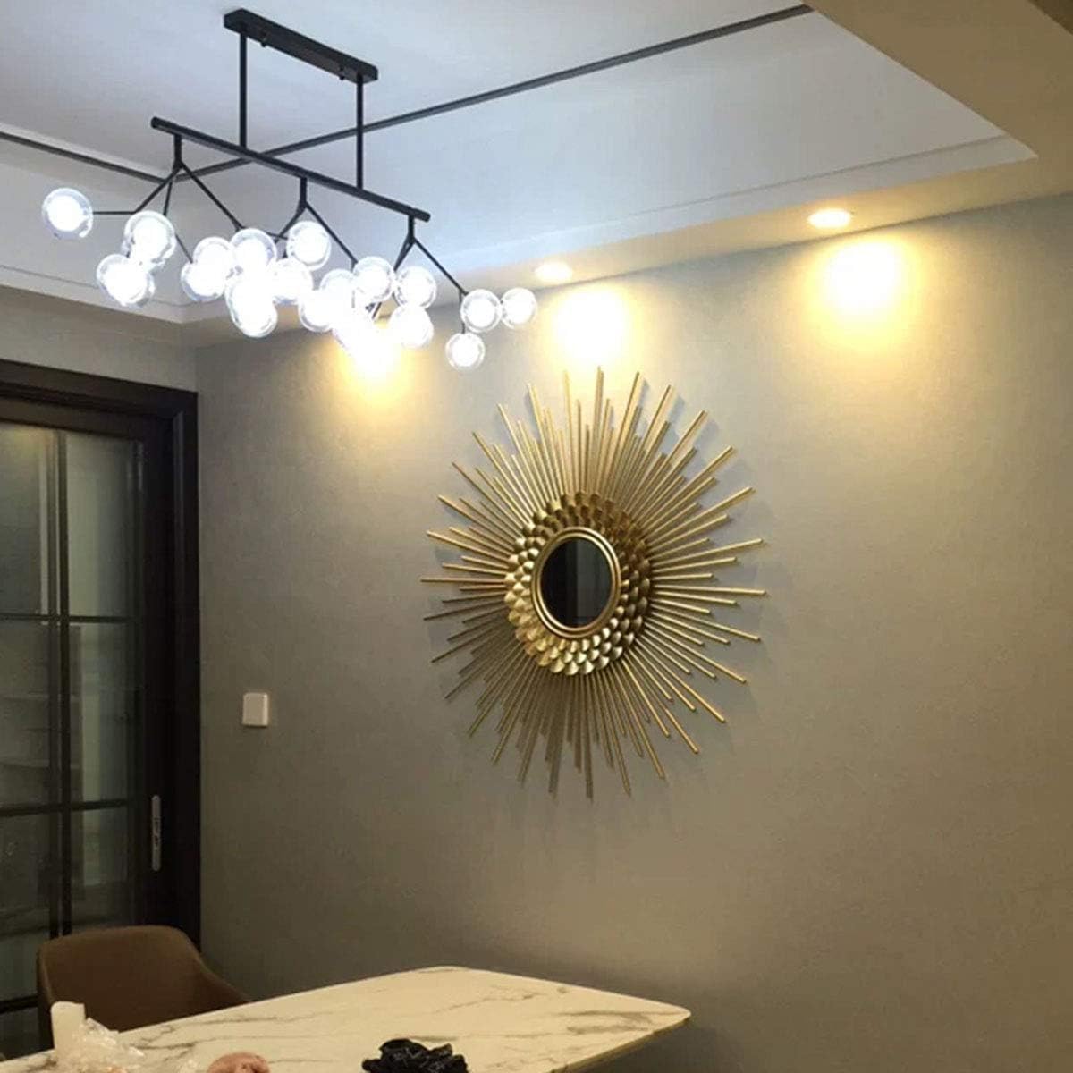 Modern interior design with a chandelier and decorative wall mirror.