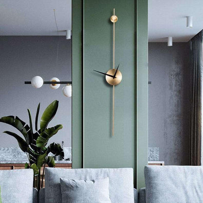 Modern wall clock on a green wall with a living room setting