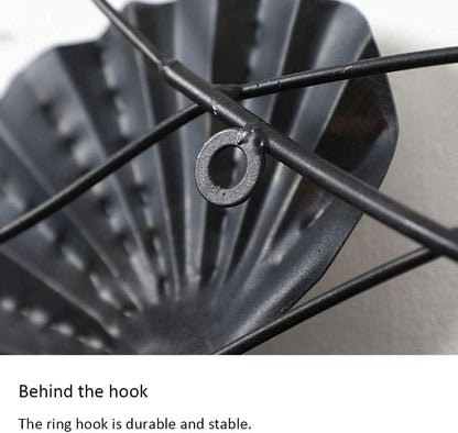 Close-up of a black metal hook with text describing its durability and stability.