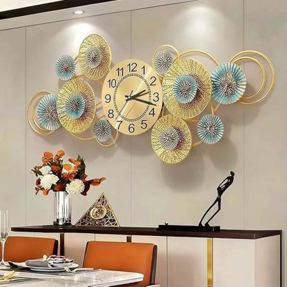 Decorative wall clock with floral designs on a wall above a dining table.