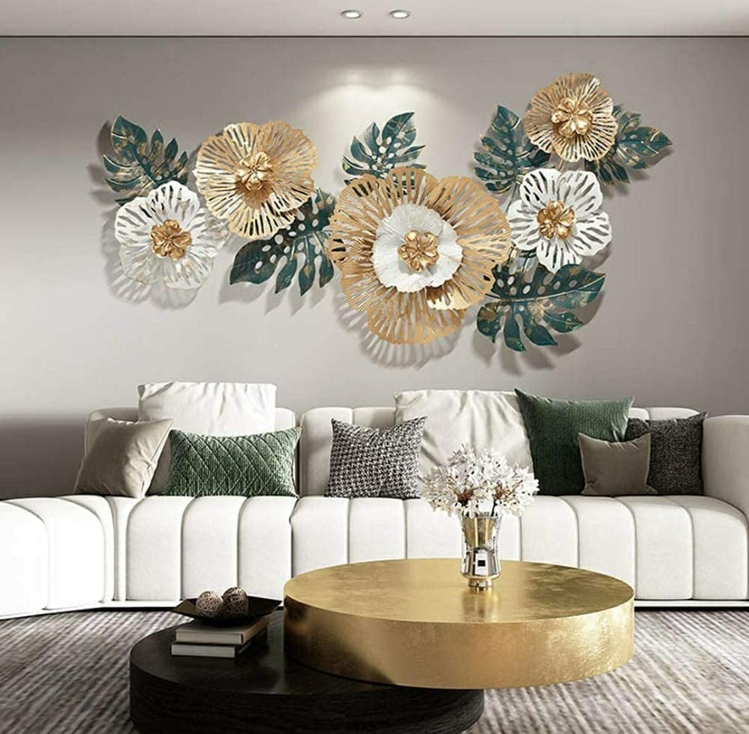 Decorative floral wall art in a living room with a white sofa and gold coffee table.