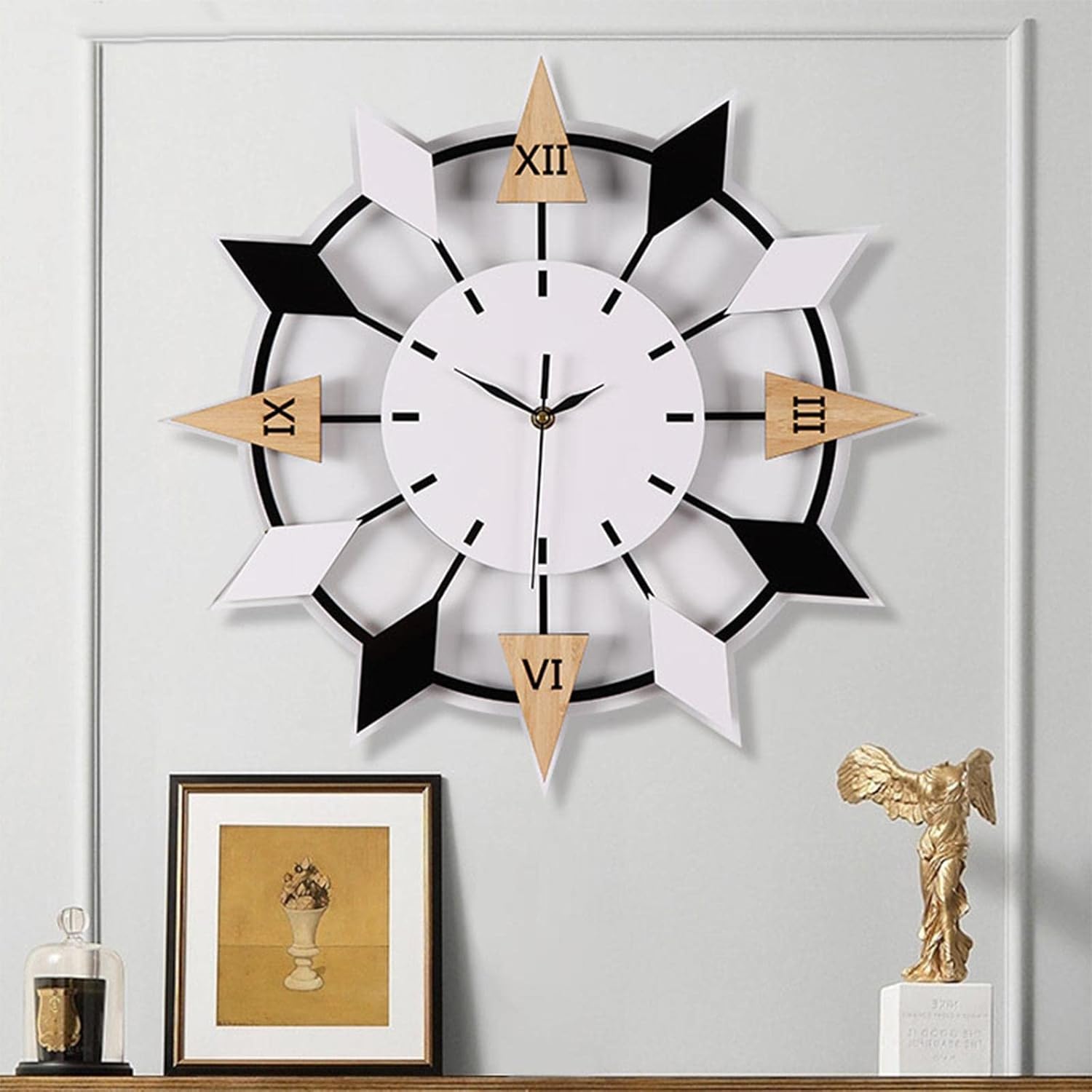 Decorative wall clock with geometric design on a wall with framed picture and sculpture.