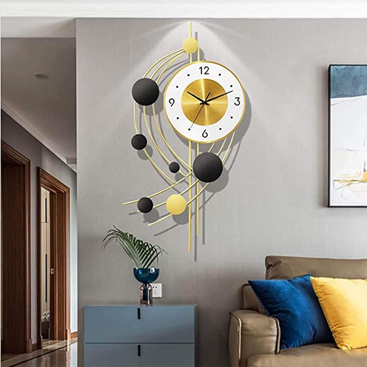 Modern wall clock with decorative elements on a gray wall in a living room.