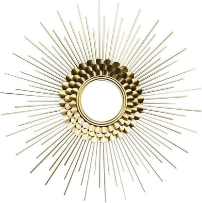 Decorative gold sunburst mirror on a white background