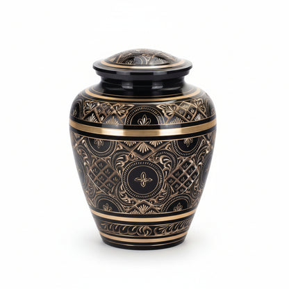 Decorative urn with intricate gold patterns on a white background