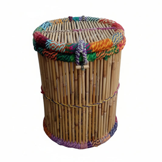 Woven basket with colorful lid on a stone pavement