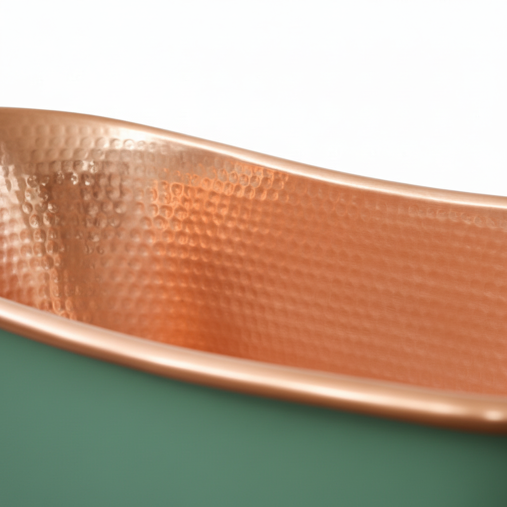 Copper tray with textured surface on a green background