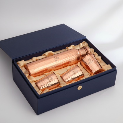 Set of copper containers in a blue box on a light gray background
