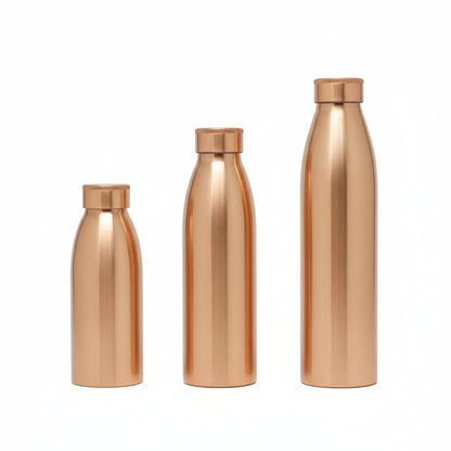 Three copper-colored water bottles on a reflective surface with a floral-patterned background.