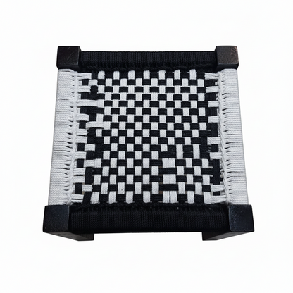 Black and white woven square with a checkered pattern on a white background