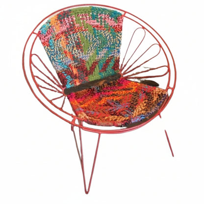 Colorful woven chair with a red metal frame on a white background