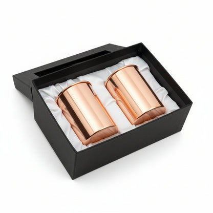 Two rose gold tumblers in a black box on a wooden surface