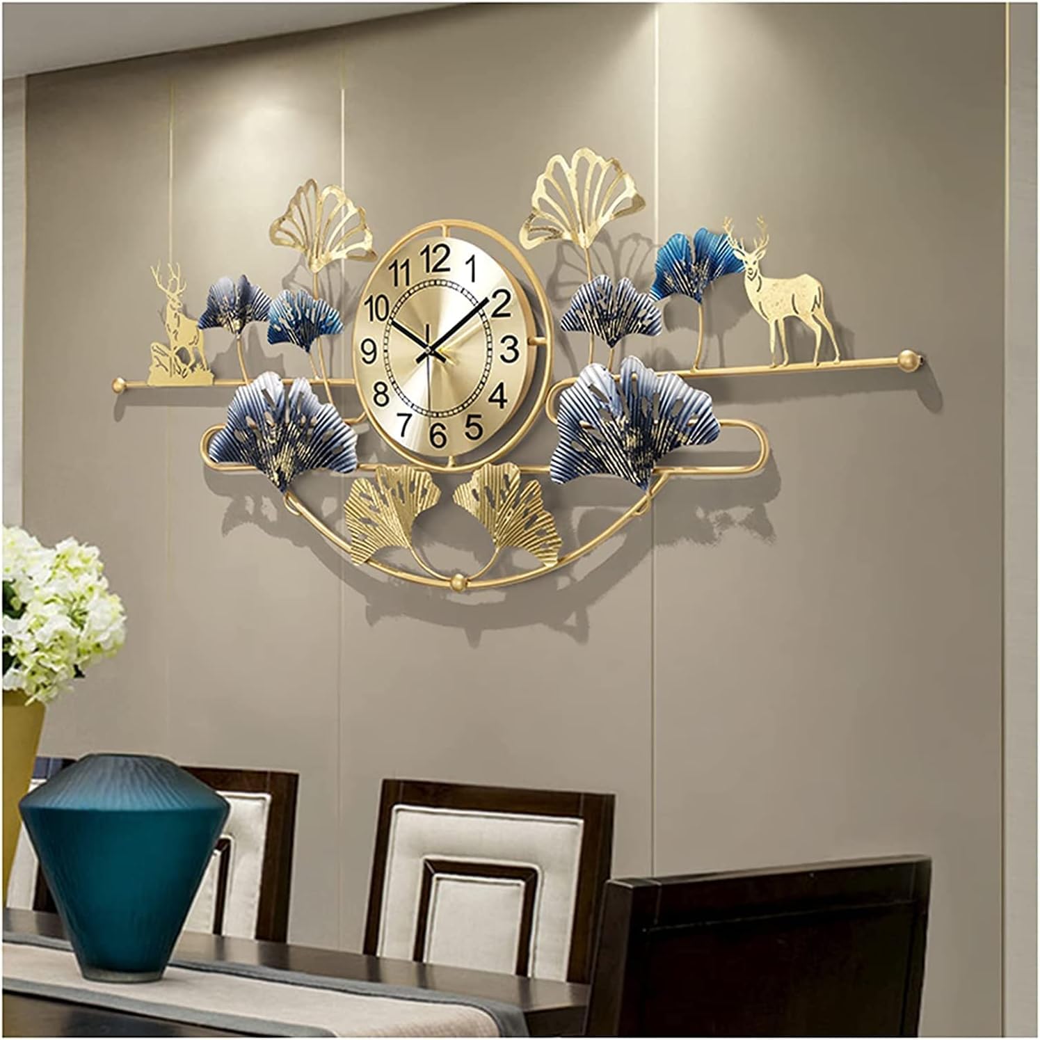 Decorative wall clock with floral and deer designs on a wall above a dining table.