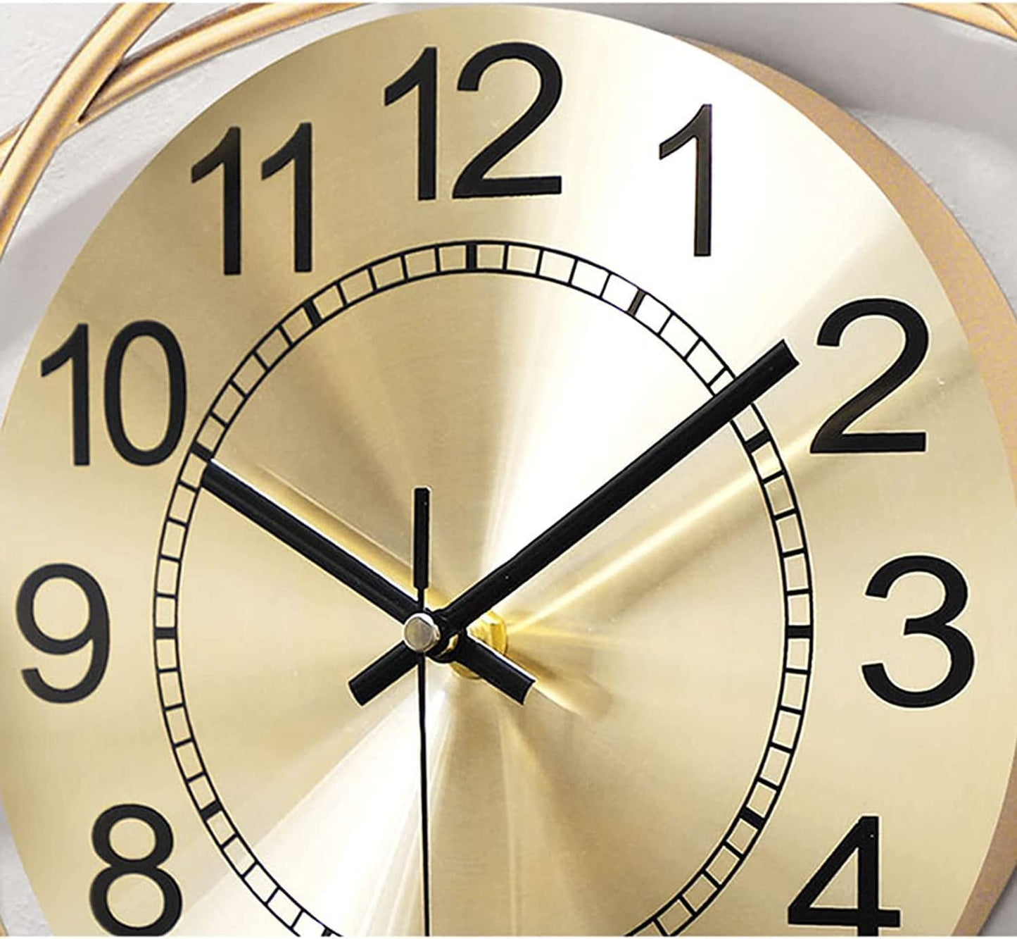 Gold clock face with black numbers and hands on a white background