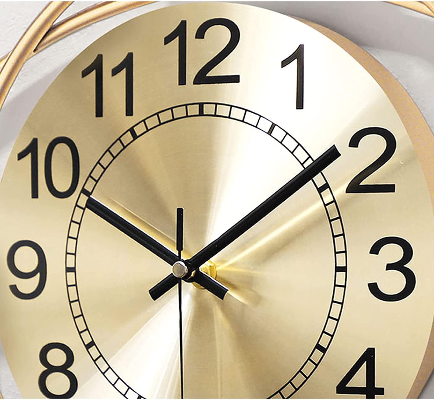 Gold clock face with black numbers and hands on a white background
