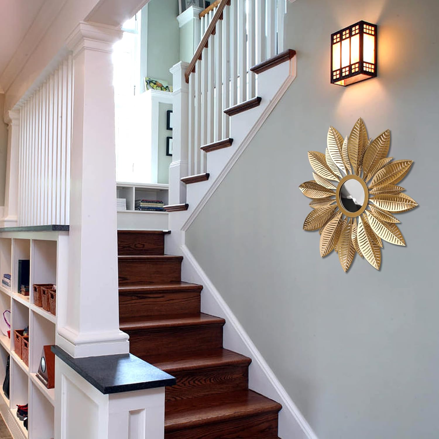 Staircase with wooden steps, white railings, and a decorative gold mirror on the wall.