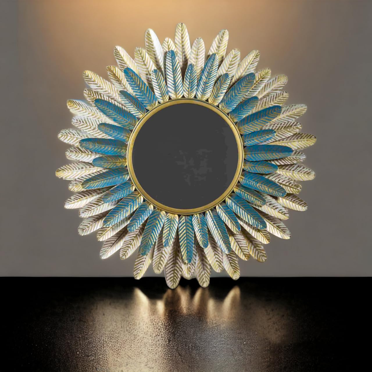 Decorative mirror with feather-like design on a dark surface and gradient background