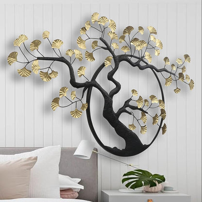 Decorative wall art of a tree with gold leaves in a bedroom setting.