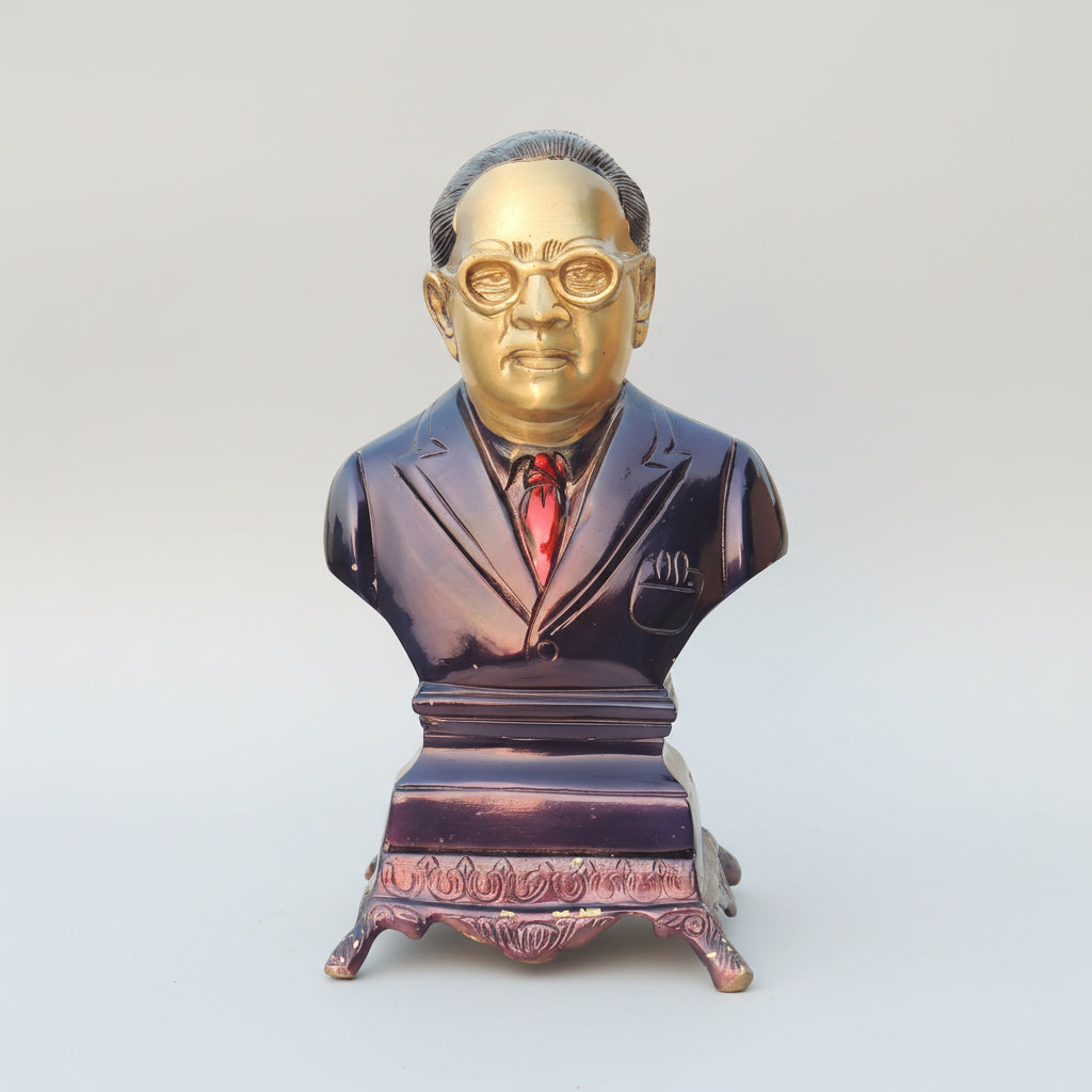 Bust sculpture of a man in a suit with gold face on a white background