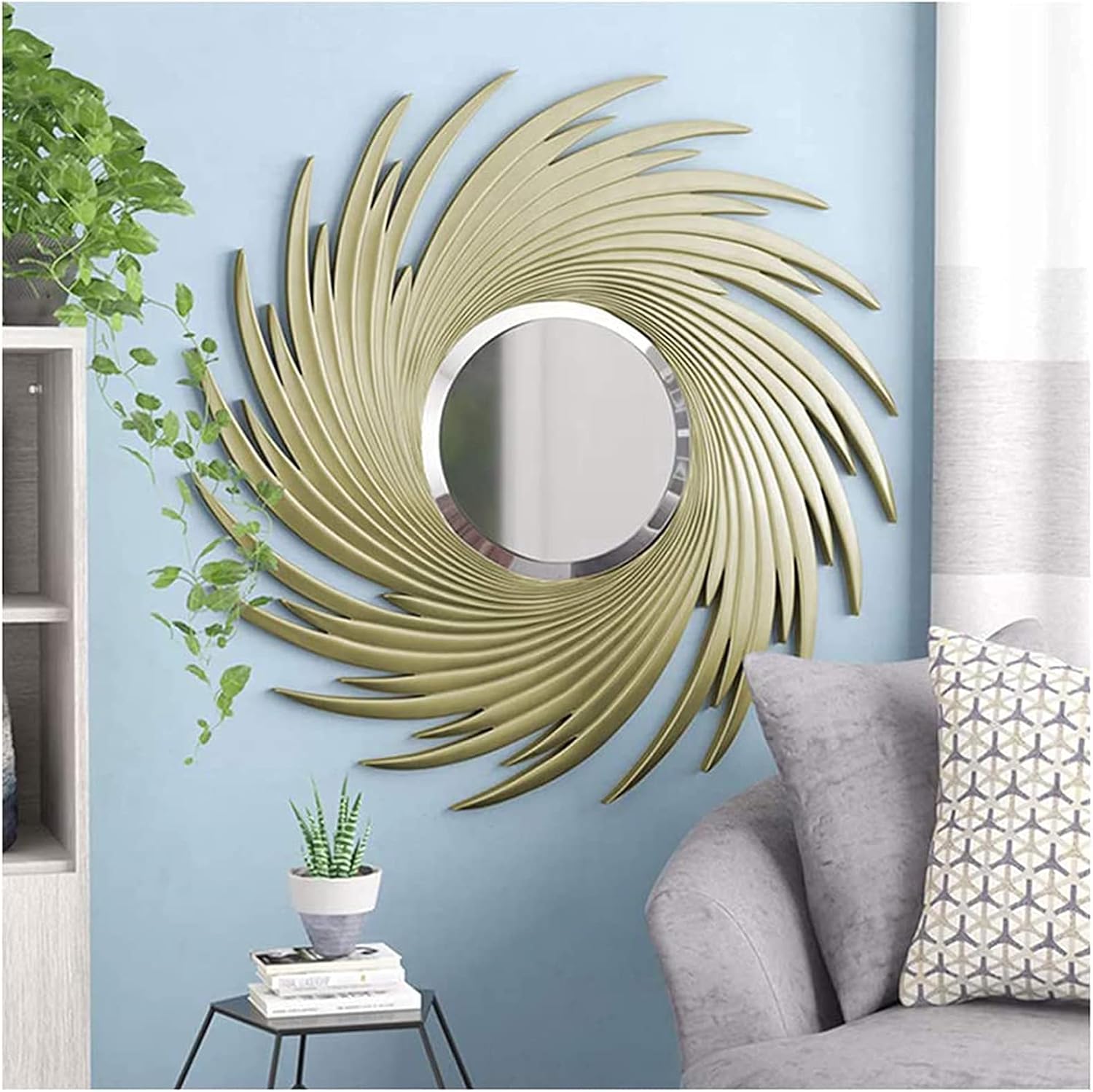 Decorative wall mirror with a spiral design on a blue wall above a sofa.