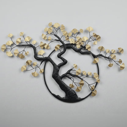 Decorative wall art of a tree with black trunk and gold leaves on a white background