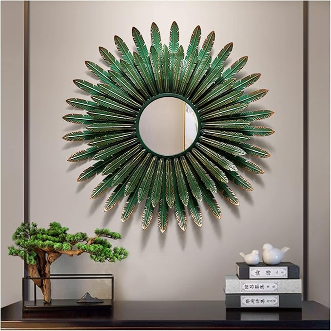 Decorative wall mirror with green leaf-like design on a neutral wall.
