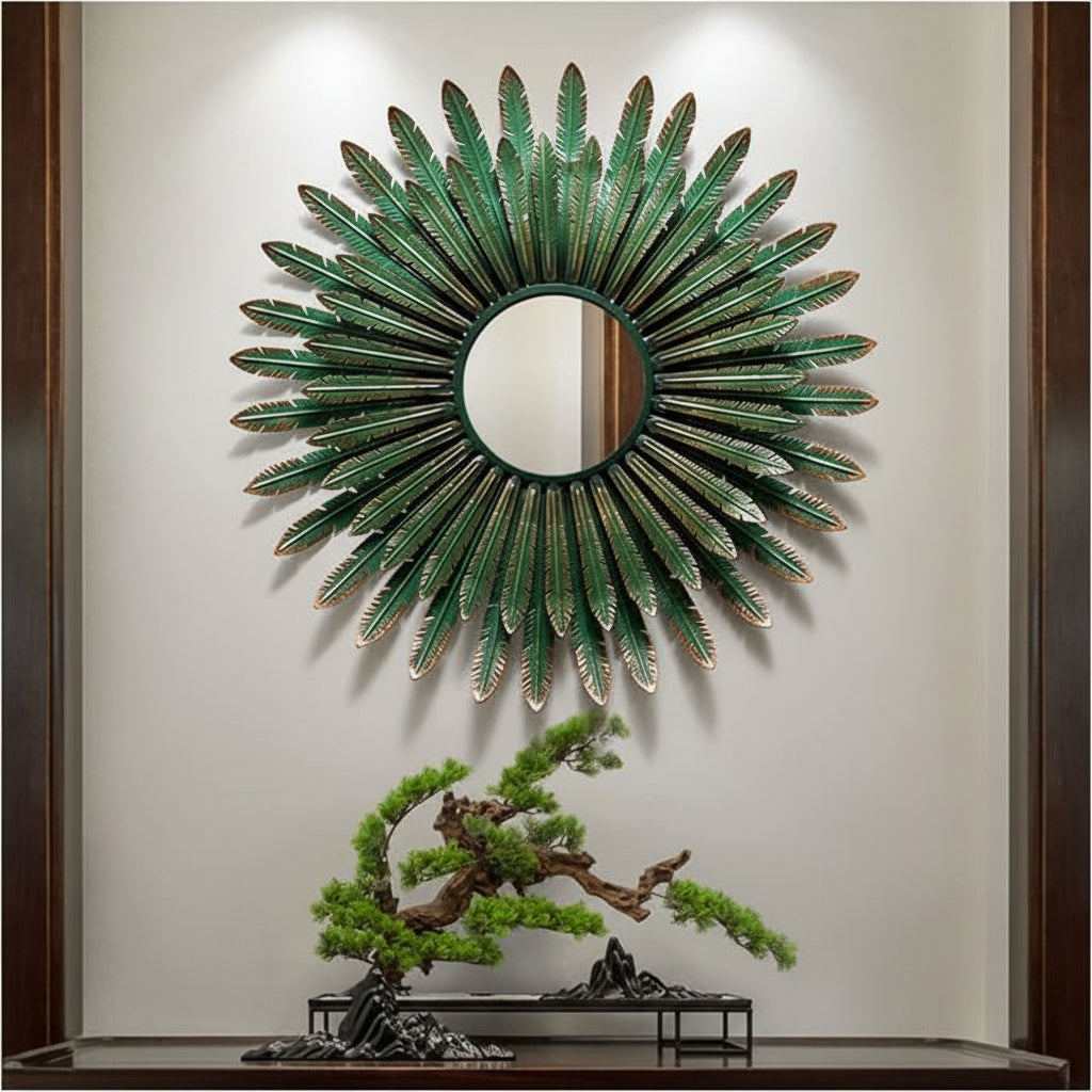 Decorative wall mirror with green leaf-like design on a neutral wall.
