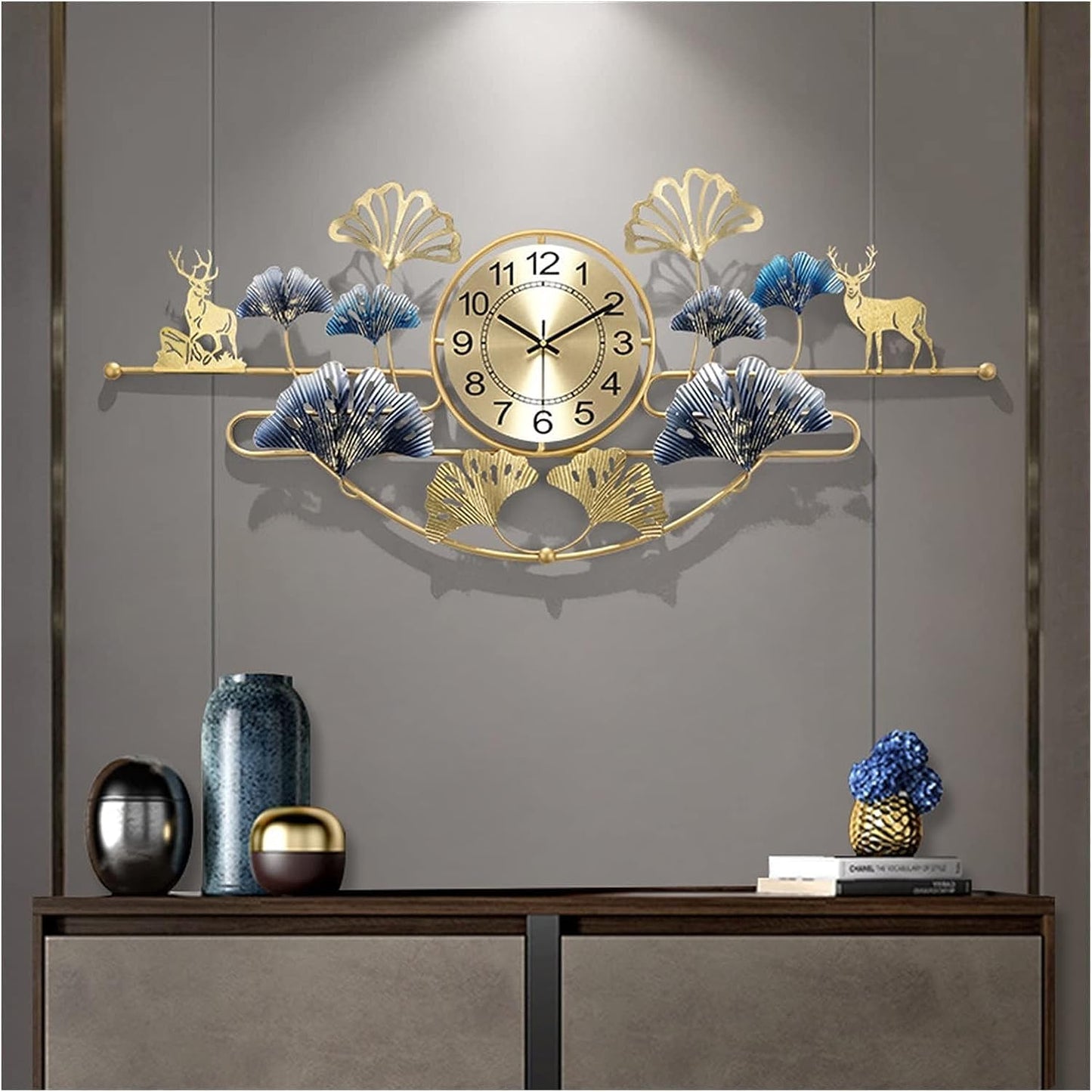 Decorative wall clock with gold accents and floral designs on a gray wall.
