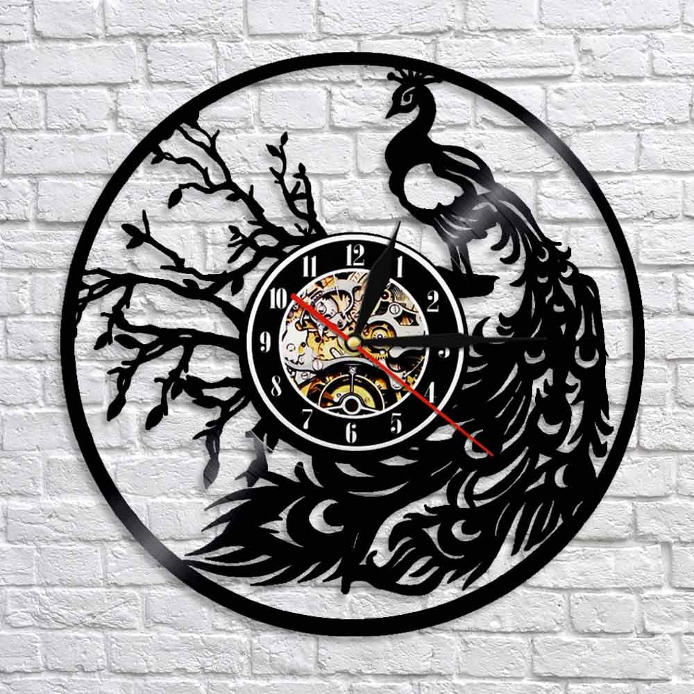 Wall clock with peacock design on a brick wall background