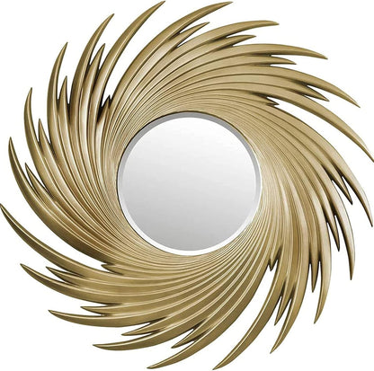 Decorative wall mirror with a gold, feather-like frame on a white background