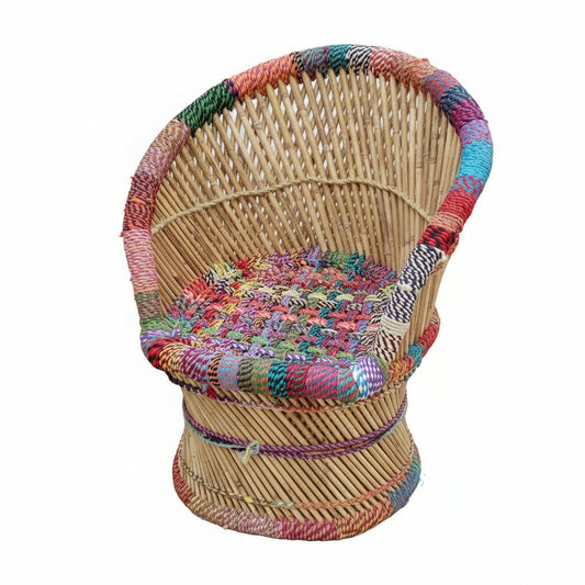 Wicker chair with colorful woven backrest on a concrete floor